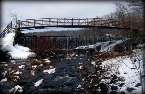 Bridge Crossing The Dam And Waterfall